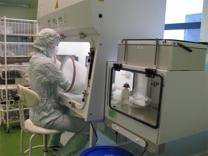 Healthcare professional wearing protective equipment while handling chemotherapy drugs