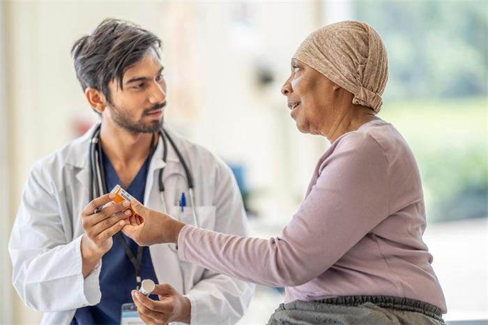 Oncologist explaining prescription medication instructions to a cancer patient